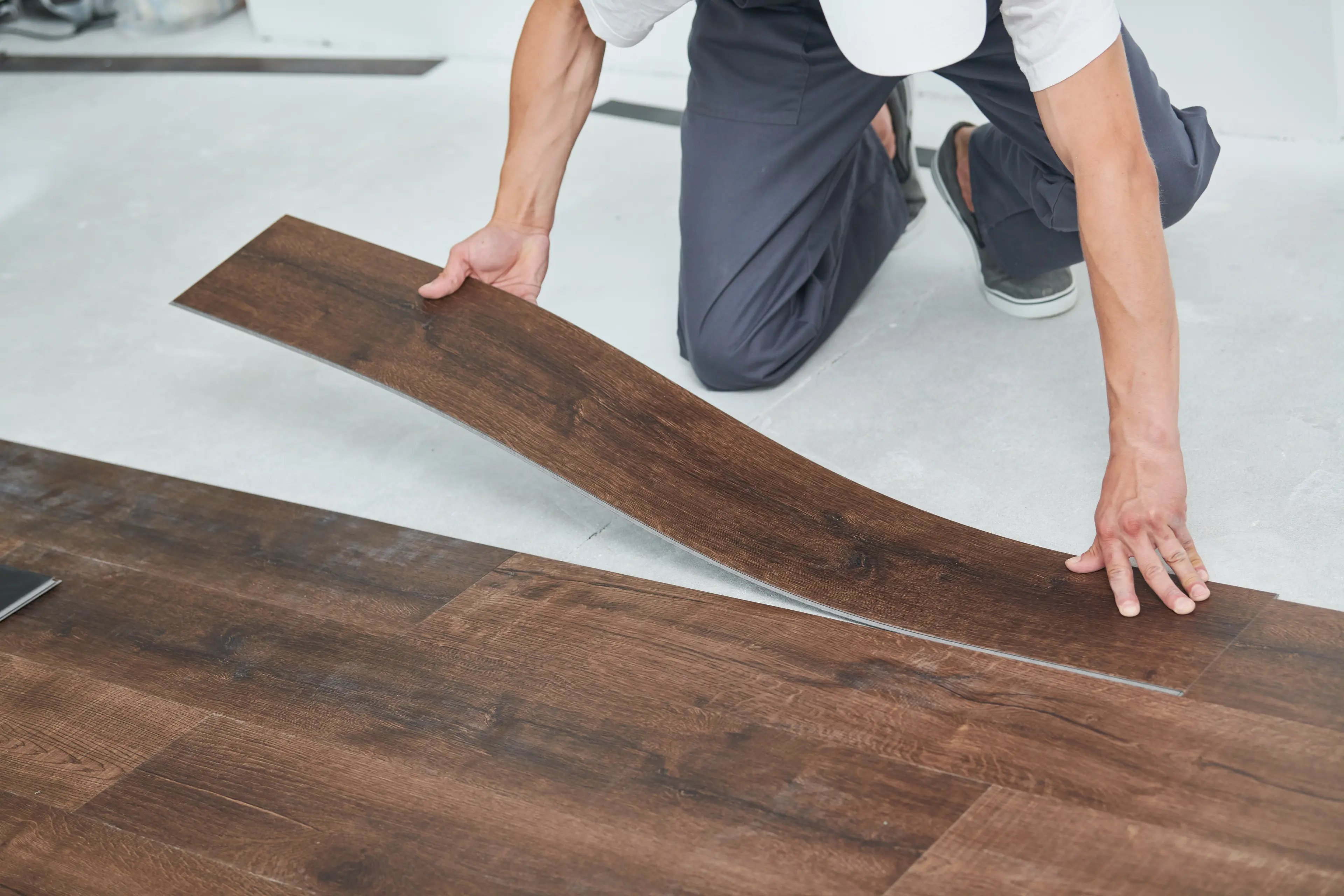 Image of a person laying vinyl flooring