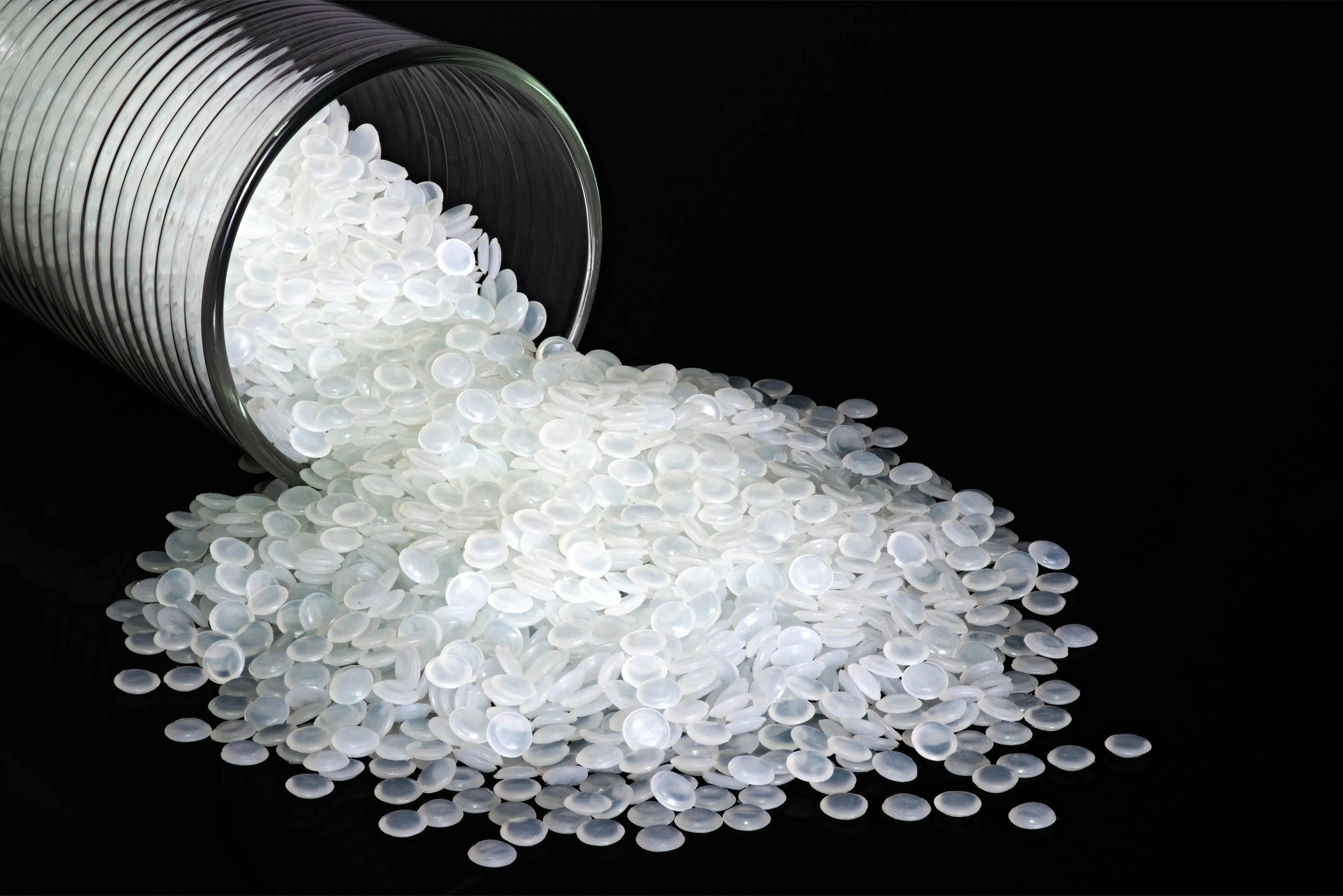 white plastic pellets on black background